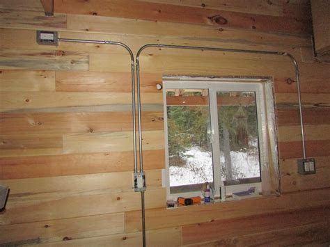 cutting electrical boxes in log homes|installing electrical wire in log house.